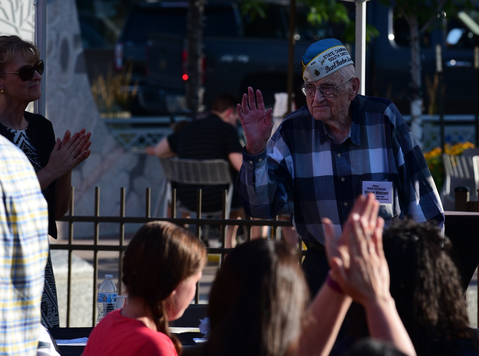 Steve Warren, the last living survivor of Pearl Harbor in South Dakota, stands as he is recognized at the 32nd Annual Military Affairs Committee Pig Roast in downtown Rapid City, S.D., July 31, 2018.