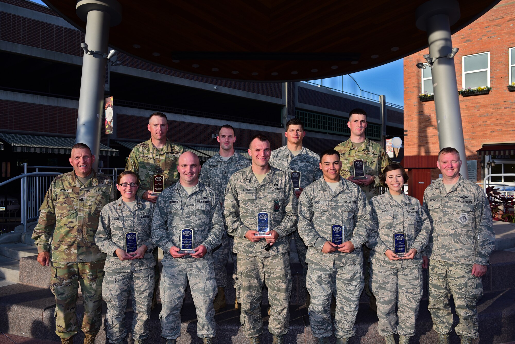 Military members stand with their awards at the end of the 32nd Annual Military Affairs Committee Pig Roast in downtown Rapid City, S.D., July 31, 2018.