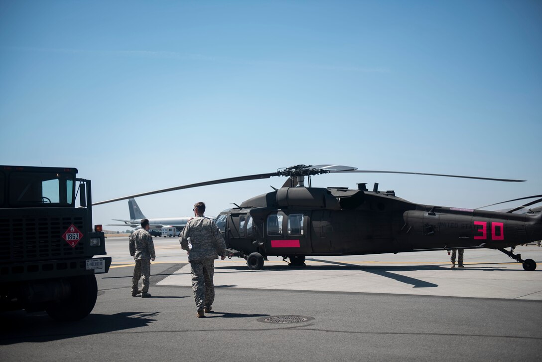 Washington National Guard petroleum, oil and lubricants Airmen from the 141st Air Refueling Wing fuel two WNG Sikorsky UH-60 Blackhawks at Fairchild Air Force Base, Washington, Aug. 1, 2018. Team Fairchild Airmen typically fuel KC-135 Stratotankers, but that skillset is flexible to allow them to fuel numerous mission partner airframes. (U.S. Air Force photo/Airman 1st Class Whitney Laine)