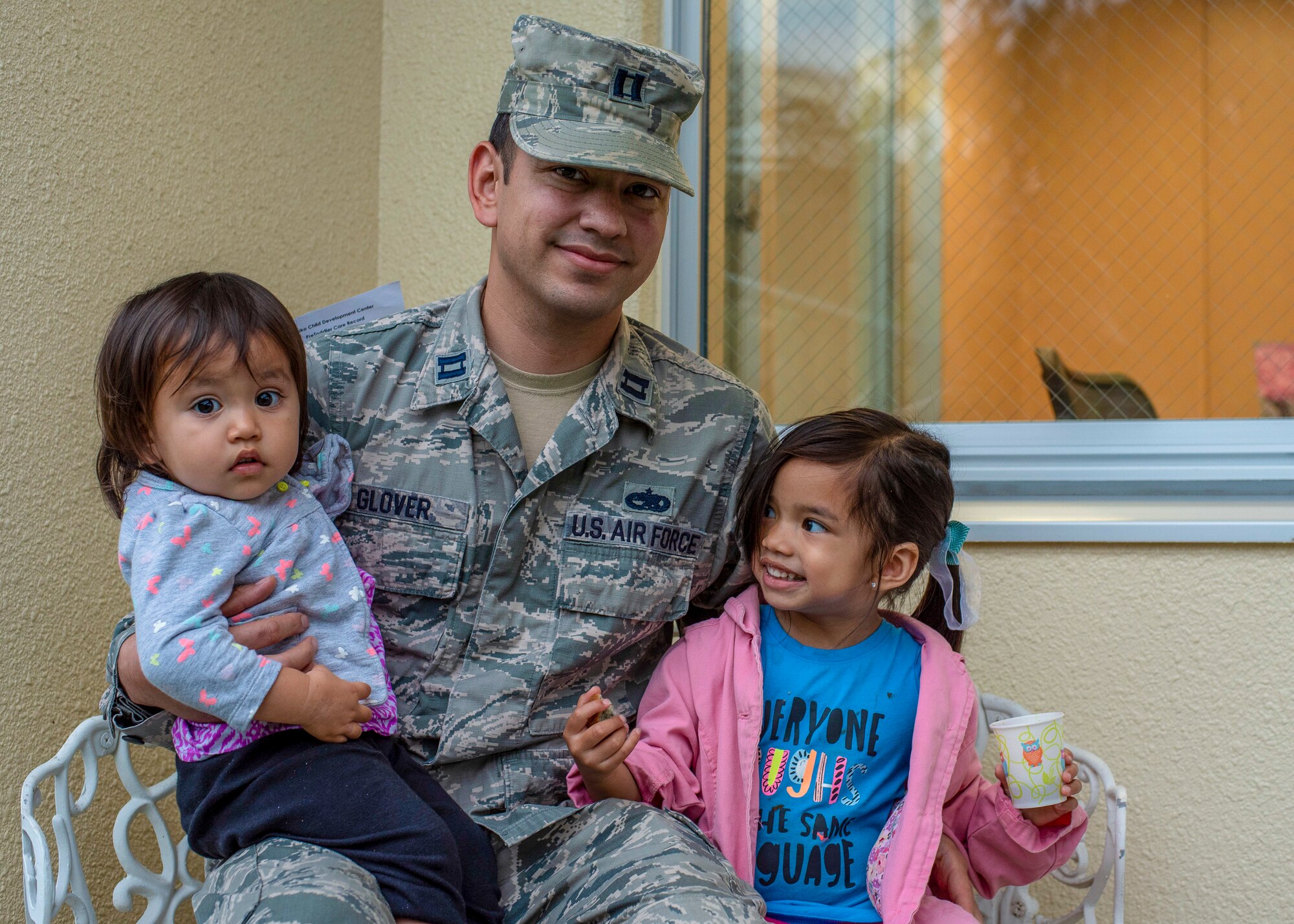 U.S. Air Force Capt. Charles Glover, the 35th Maintenance Squadron Operations officer, and his two daughters pause for a photo outside the Child Development Center at Misawa Air Base, Japan, July 18, 2018. Glover has three daughters, ranging from ages one to nine years old. While Glover wears a variety of hats in his personal and professional life, his favorite cap to sport is being a father. (U.S. Air Force photo by Airman 1st Class Collette Brooks)