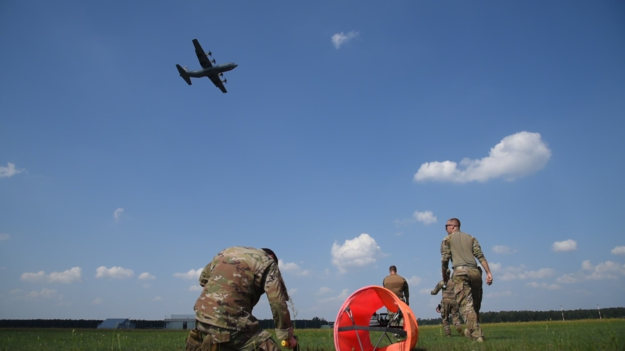 U.S. Airmen from the 435th Contingency Response Group establish a landing zone on a grass field for the C-130J Super Hercules to practice landing in an austere environment as part of an exercise on Powidz Air Base, Poland, July 31, 2018. Approximately 100 Airmen and three aircraft arrived in Poland to conduct bilateral exercises with the Polish Air Force. (U.S. Air Force photo by Senior Airman Kirsten Brandes)