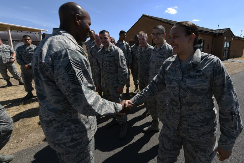 Chief Master Sgt. of the Air Force Kaleth O. Wright greets a Liberty Wing Airman during an immersion tour, Aug. 1, 2018 at Royal Air Force Lakenheath, England. During his visit, Wright met with 48th Fighter Wing Airmen to answer questions and see how they take care of the mission.  (U.S. Air Force photo/Airman 1st Class Christopher S. Sparks)