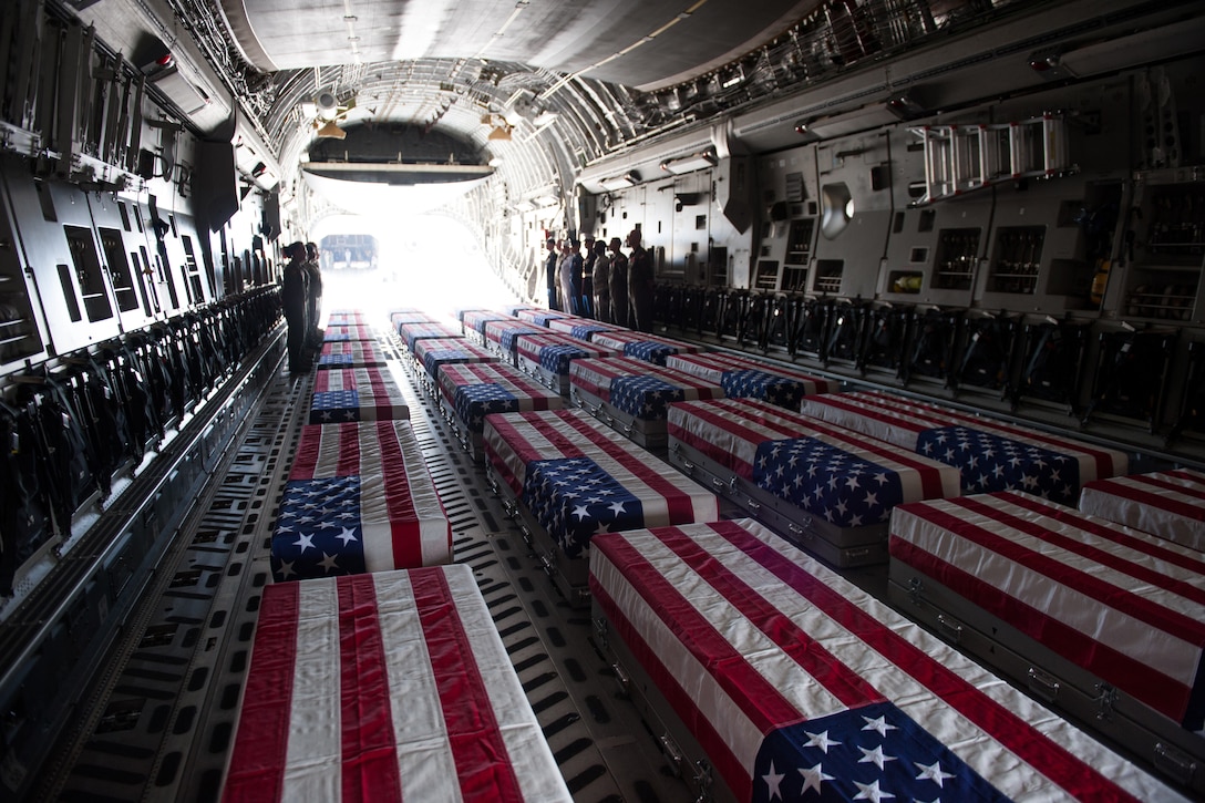 Transfer cases, containing the remains of what are believed to be U.S. service members lost in the Korean War, line a U.S. Air Force C-17 Globemaster III aircraft during an honorable carry ceremony at Joint Base Pearl Harbor-Hickam, Hawaii, Aug. 1, 2018.