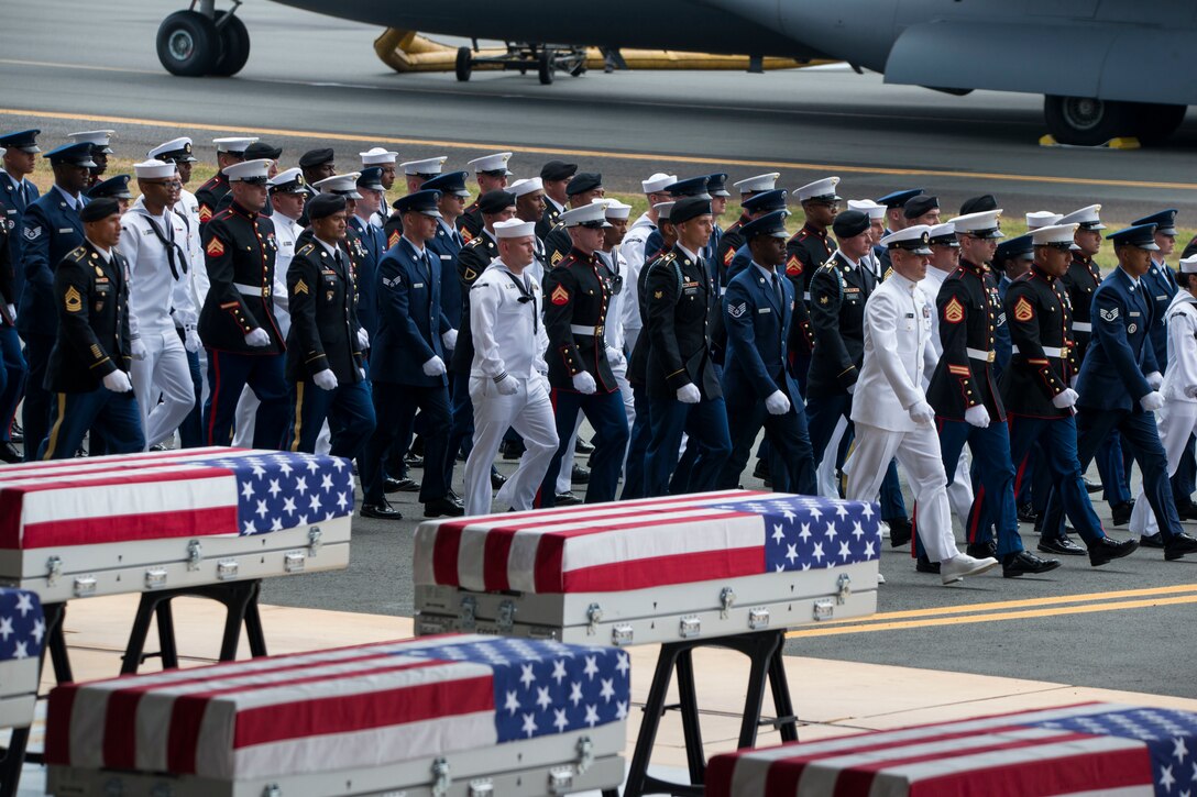 Service members march in formation during an honorable carry ceremony at Joint Base Pearl Harbor-Hickam, Hawaii, Aug. 1, 2018.