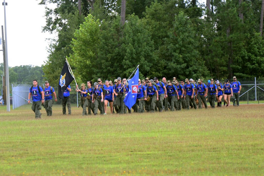 Marines, Sailors and Gold Star family members with the U.S. Marine Corps Forces, Special Operations Command arrive at the parade field aboard Marine Corps Base Camp Lejeune, N.C., during the Marine Raider Memorial March, July 27, 2018. A ceremony marked the completion of the 900-mile march beginning in Mississippi and ending in North Carolina over the course of 10 days in honor of fallen Raiders. (U.S. Marine Corps photo by Sgt. Janessa K. Pon)