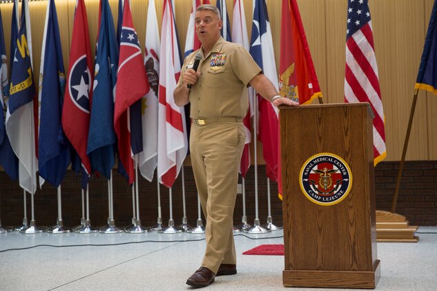 Capt. James Hancock, commanding officer of Naval Medical Center Camp Lejeune, welcomes therapy dog, Pappy Boyington, to NMCCL, N.C., during a special debut, July 10, 2018. Pappy is the first therapy dog to offer support to patients and staff at NMCCL. (U.S. Marine Corps photo by Lance Cpl. Nathan Reyes)