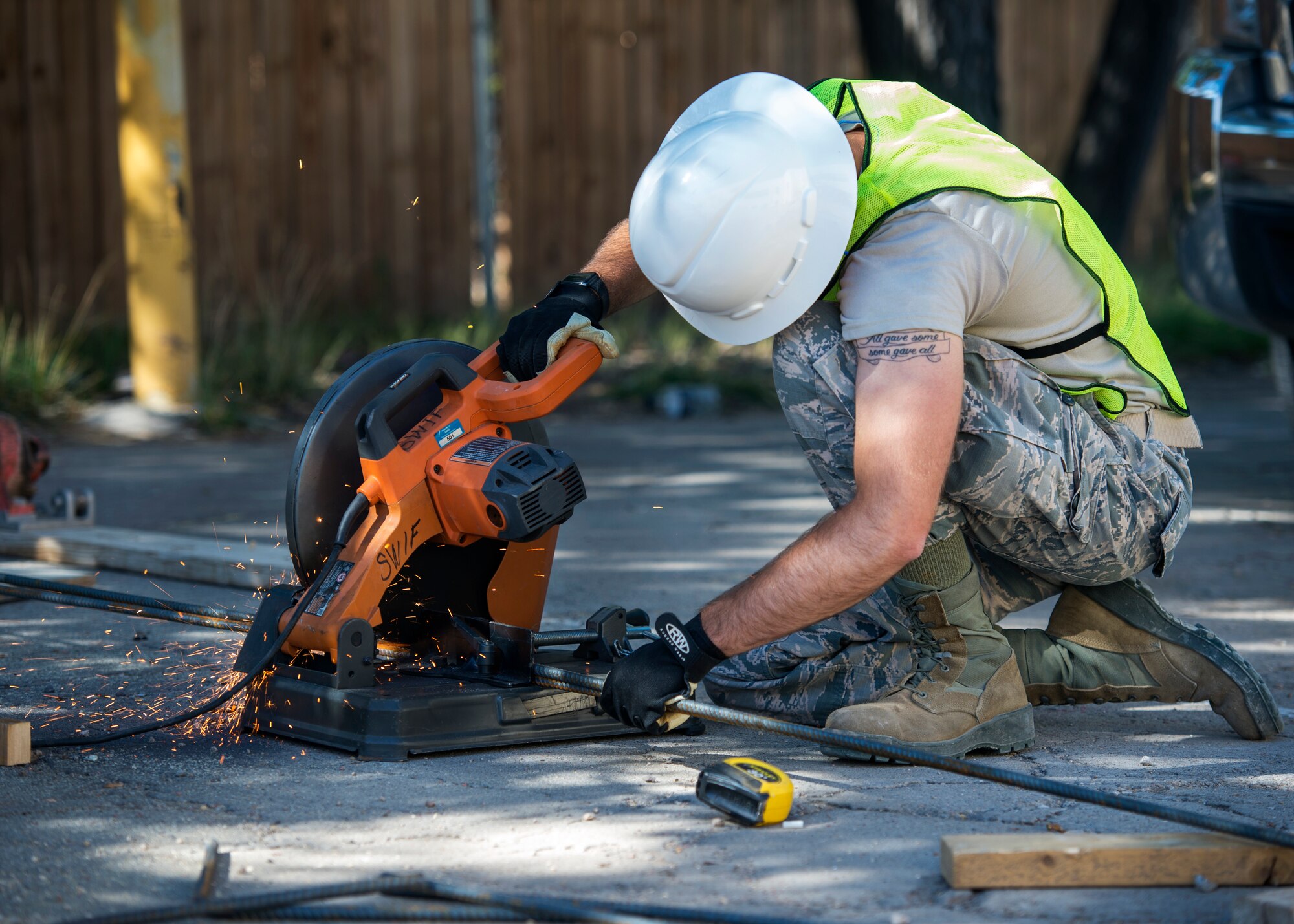 U.S. Air Force Airman 1st Class Keegan Geske, 133rd Civil Engineer Squadron Utilities shop, cuts a piece of rebar that will be used to reinforce a concrete footing on a handicap ramp for the St. Francis Catholic School in Gallup, N.M., July 24, 2018.