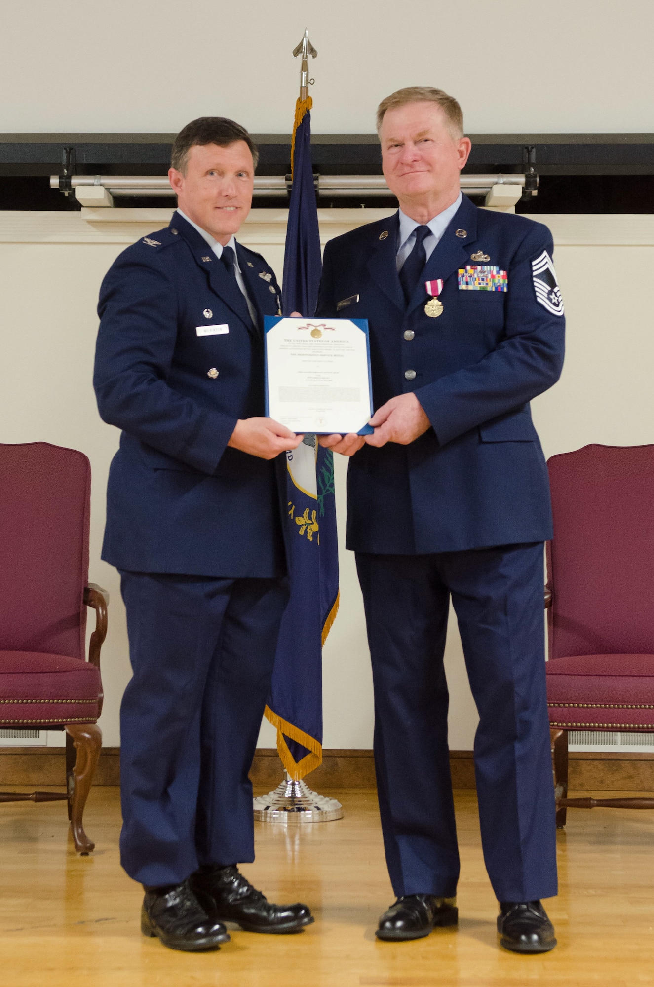 Col. Jeffrey Wilkinson (left), commander of the Kentucky Air National Guard’s 123rd Airlift Wing, presents a Meritorious Service Medal to Chief Master Sgt. David Selby during Selby’s retirement ceremony at the Kentucky Air National Guard Base in Louisville, Ky., May 19, 2018. Selby, the 123rd Mission Support Group superintendent, served for 39 years in the Kentucky Air National Guard. (U.S. Air National Guard photo by Master Sgt. Vicky Spesard)