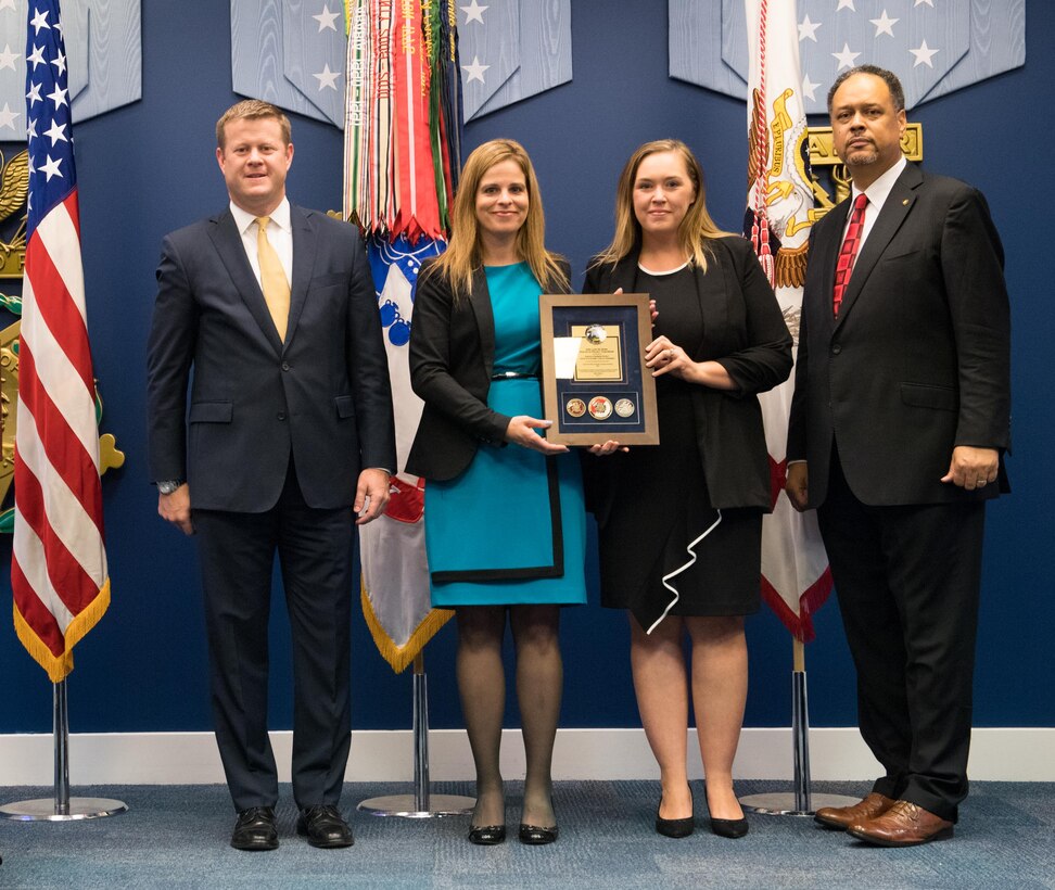 Undersecretary of the Army Ryan D. McCarthy (Left) presents the Army’s Lean Six Sigma Process Improvement Program Team Excellence Award in the Non-Enterprise, Non-Gated Level July 25, 2018 to Ashley Klimaszewski, supervisory real estate specialist with the Louisville District (formerly with the Nashville District – Second from Left), and Kathryn Wall, Nashville District Real Estate Division realty specialist, during the 2017 Lean Six Sigma Excellence Awards Program Ceremony in the Hall of Heroes at the Pentagon in Arlington Va.  Dr. Charles Brandon, director of the Office of Business Transformation, joined McCarthy for the presentation. (U.S. Army photo by Staff Sgt. Brandy N. Mejia)