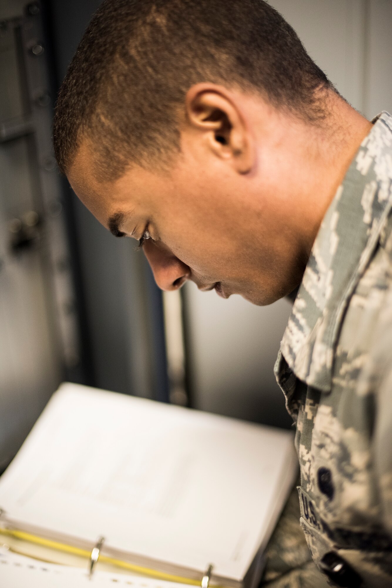 U.S. Air Force Staff Sergeant Dorian Brooks, reviews an Air Force Operating Instruction prior to conducting routine maintenance.