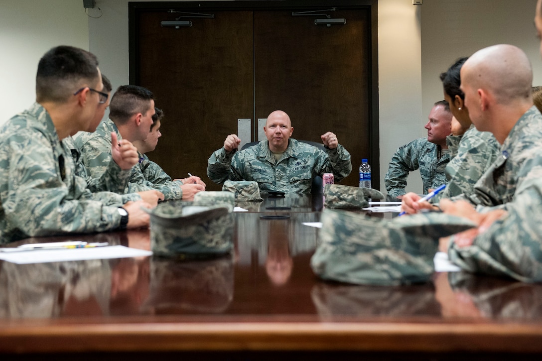 Chief Master Sgt. Brandon Dunston, center, 23d Aircraft Maintenance Squadron superintendent, talks with Air Force Reserve Officer Training Corps cadets during Operation Air Force 2018, July 18, 2018, at Moody Air Force Base, Ga. From June 2-Aug. 1, three groups of cadets from across the nation participated in the annual program which gave them an opportunity to see the operational Air Force’s mission and lifestyle before choosing a career as an officer. (U.S. Air Force photo by Airman 1st Class Erick Requadt)