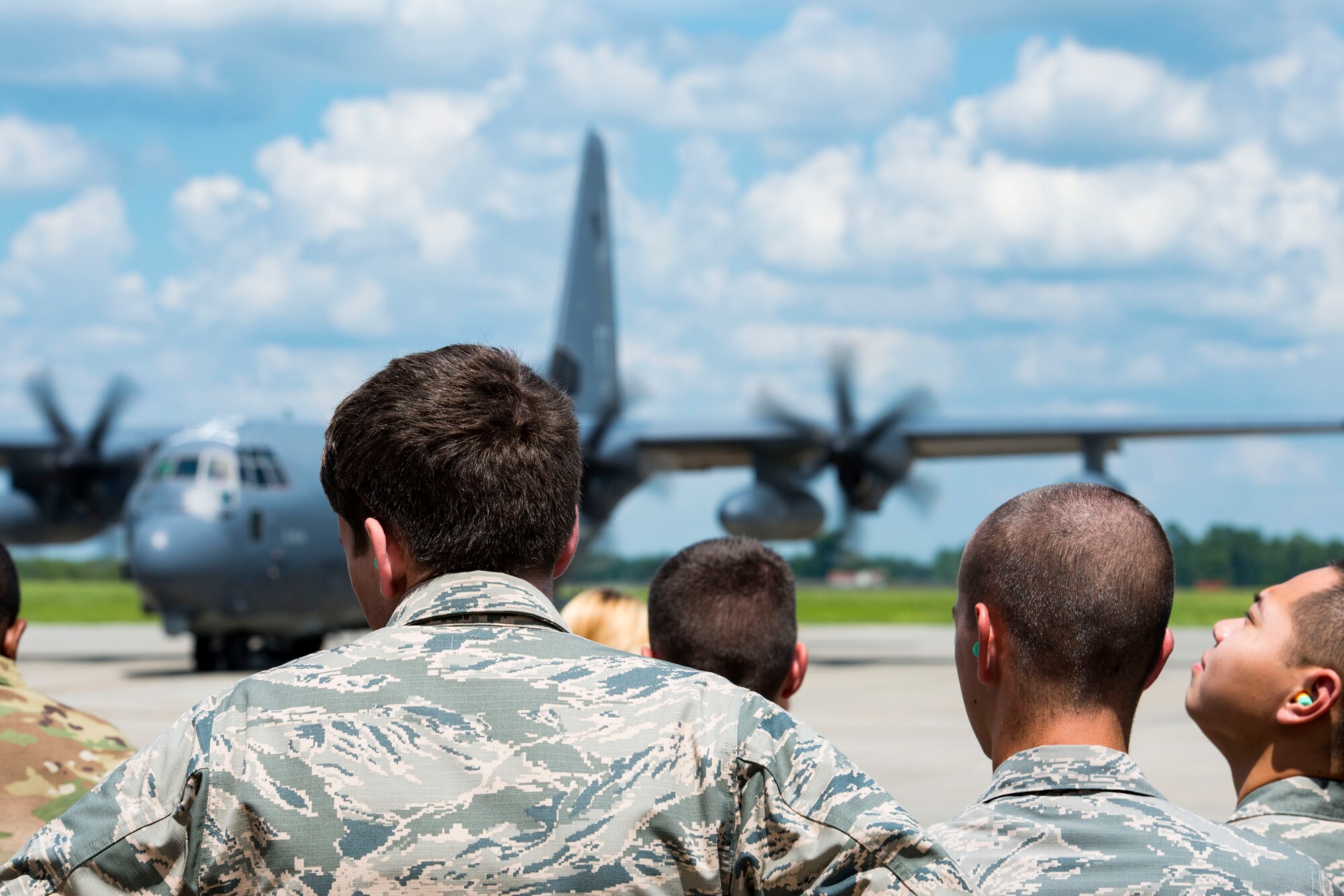 Air Force Reserve Officer Training Corps cadets watch an HC-130J Combat King II taxi on the flightline during Operation Air Force 2018, July 26, 2018, at Moody Air Force Base, Ga. From June 2-Aug. 1, three groups of cadets from across the nation participated in the annual program which gave them an opportunity to see the operational Air Force’s mission and lifestyle before choosing a career as an officer. (U.S. Air Force photo by Airman 1st Class Erick Requadt)
