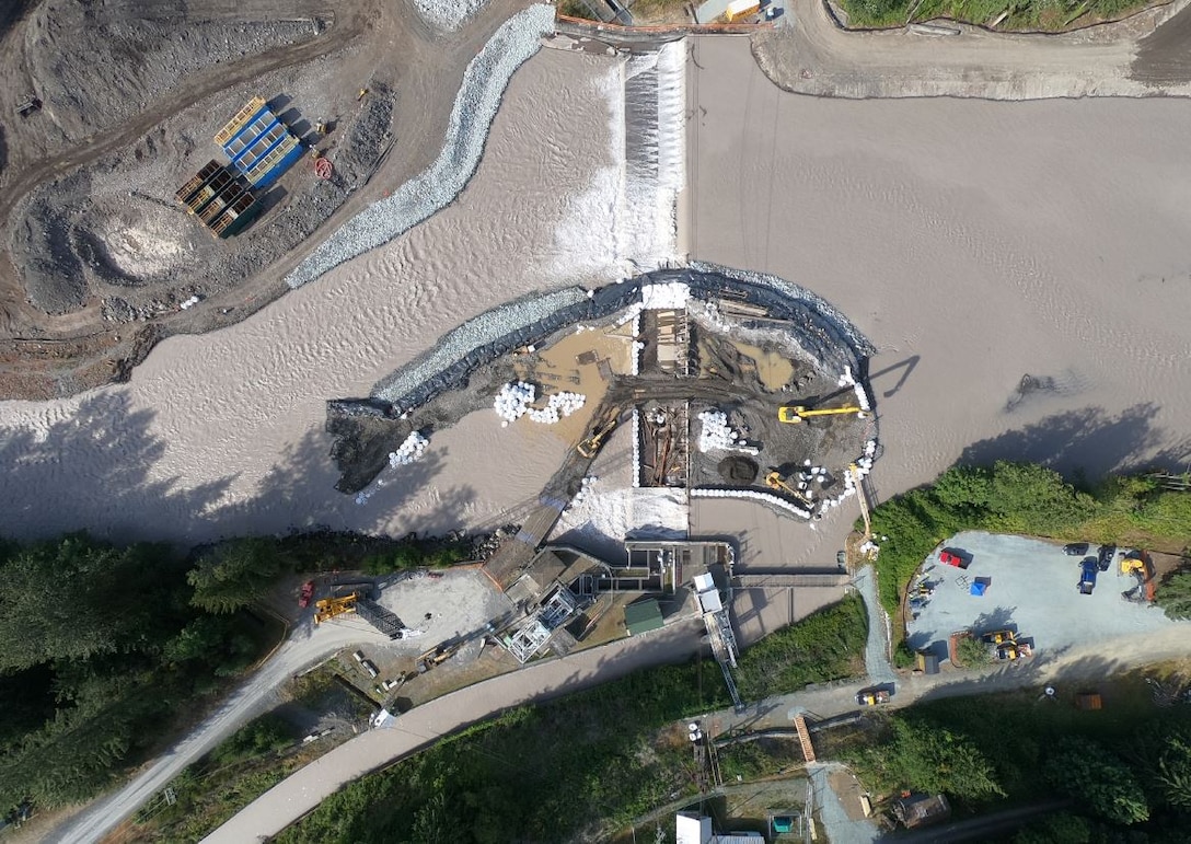 The U.S. Army Corps of Engineers began construction on the new $112 million Mud Mountain Dam Fish Passage Facility. Kiewit Infrastructure West Company, provided this video of them diverting the White River to isolate the left bank for demolition of the existing barrier dam to begin construction of the new project.