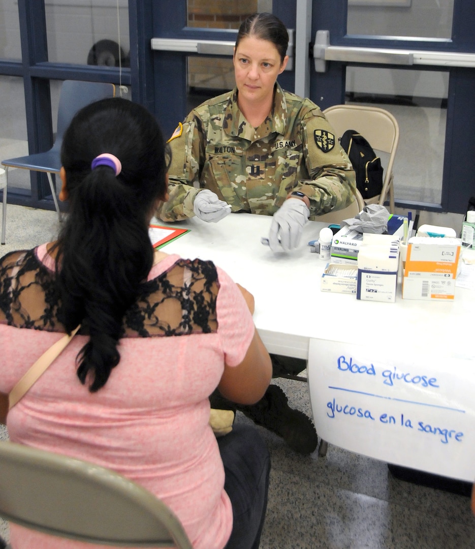 Capt. Amy Walton, a medical surgical nurse, completes a blood glucose screening for local residents waiting for medical services at Betty Harwell Middle School in Edinburg, Texas. Approximately 50 U.S. Army Reserve Soldiers assigned to the 7235th Medical Support Unit out of Orlando, Texas, worked in partnership with the Texas A&M Colonias program June 16-27 to provide medical care to Hidalgo County's underserved colonia population. Services provided by military personnel are done through the Department of Defense's Innovative Readiness Training, a civil-military program that builds mutually beneficial partnerships between U.S. communities and the DOD. The missions selected meet training and readiness requirements for Army Reserve service members while integrating them as a joint and whole-of-society team to serve our American citizens.