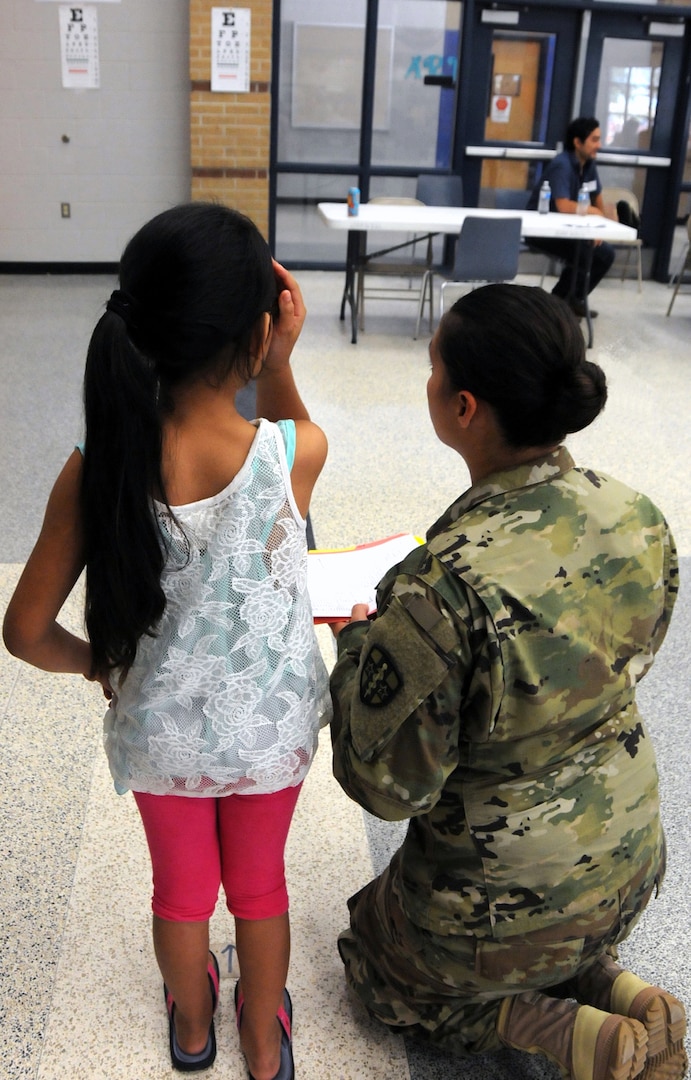 Spc. Launa Bailey, a combat medic, completes an eye screening for local residents waiting for medical services at Betty Harwell Middle School in Edinburg, Texas. Approximately 50 U.S. Army Reserve Soldiers assigned to the 7235th Medical Support Unit out of Orlando, Texas, worked in partnership with the Texas A&M Colonias program June 16-27 to provide medical care to Hidalgo County's underserved colonia population. Services provided by military personnel are done through the Department of Defense's Innovative Readiness Training, a civil-military program that builds mutually beneficial partnerships between U.S. communities and the DOD. The missions selected meet training & readiness requirements for Army Reserve service members while integrating them as a joint and whole-of-society team to serve our American citizens.