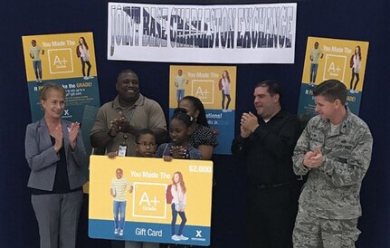 Gerald Wells, a fifth-grade resident of Joint Base Charleston, accepts a $2,000 grand prize as part of a sweepstakes for academic excellence at the Exchange on JB Charleston Aug. 1, 2018. Through the Exchange's "You Made the
Grade" program, 1st-through 12th-graders with a B average or higher are eligible to enter the sweepstakes for a chance at a $2,000, $1,500 or $500 Exchange gift card. Gerald was randomly selected as the grand-prize winner
from more than 900 entries.