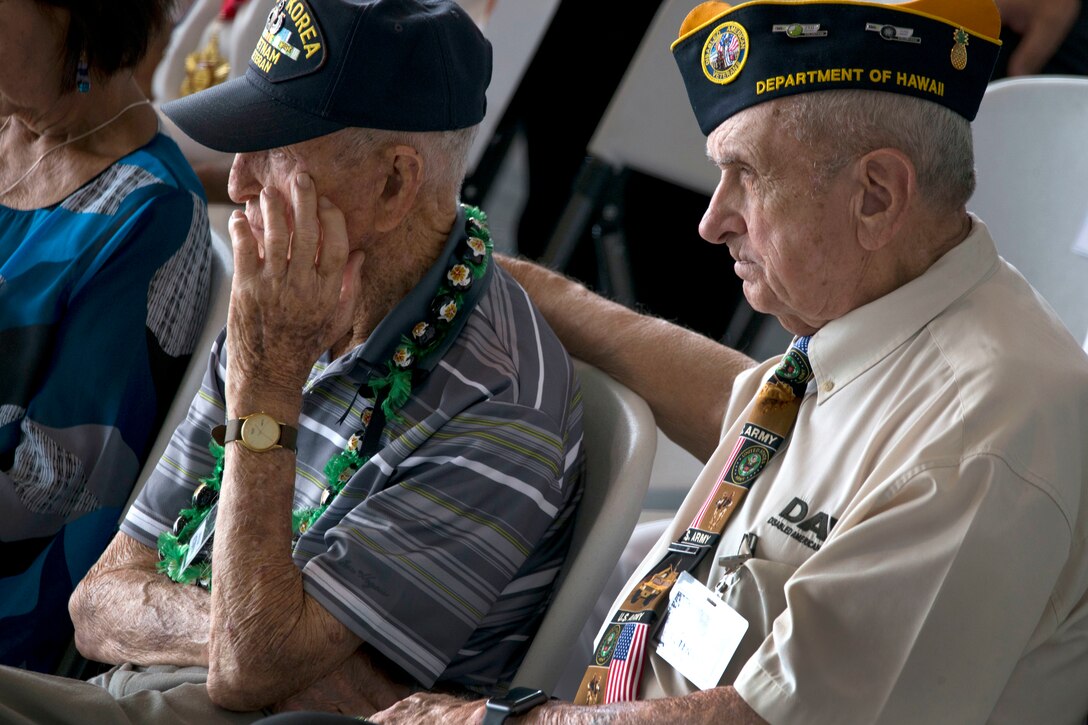 Two veterans sit next to each other.