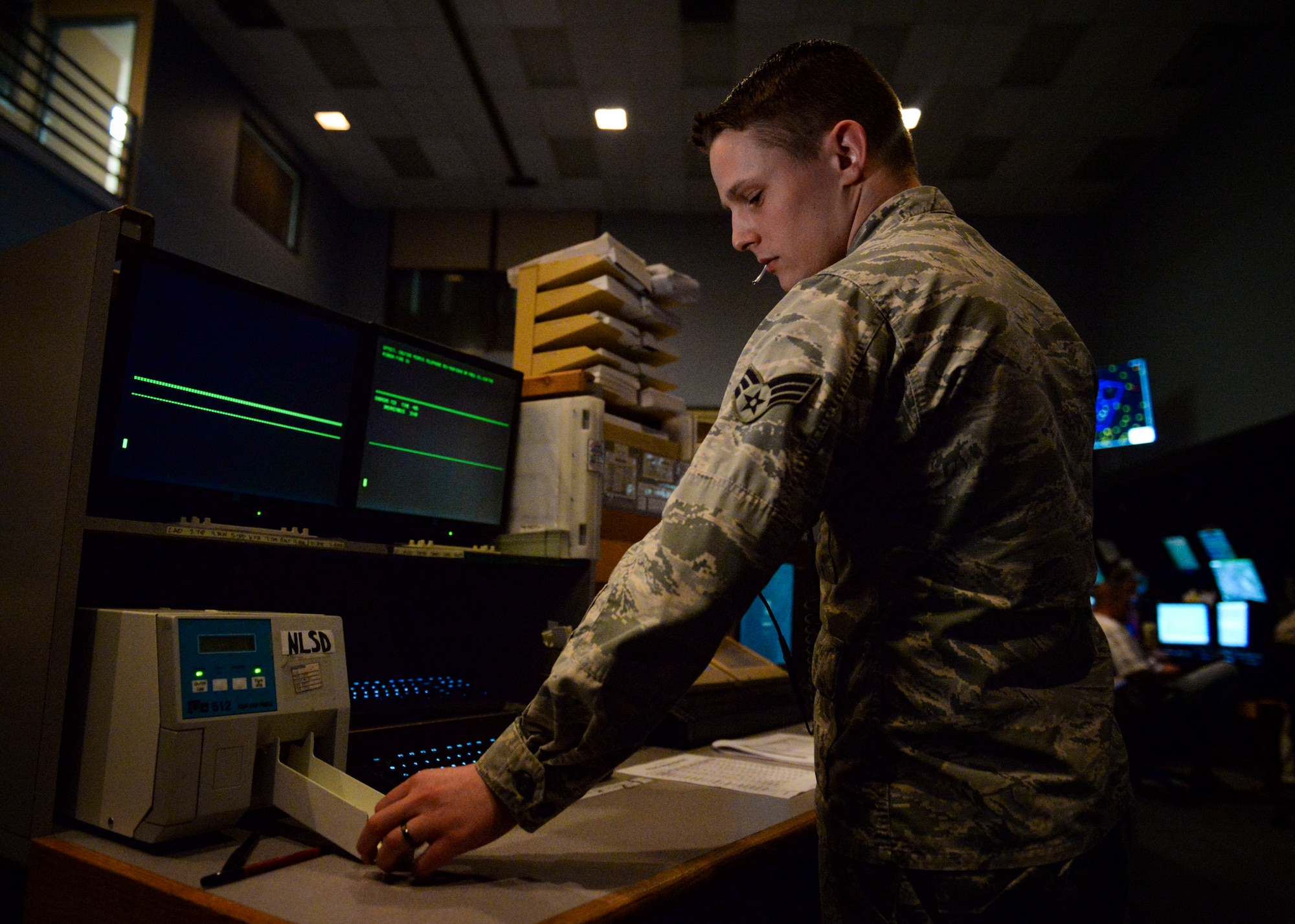 Senior Airman Orion Furber, air traffic controller (ATC) assigned to the 57th Operation Support Squadron, prepares flight information for the scope controllers at the Nellis Air Traffic Control Facility. ATC specialists are responsible for the safety and guidance of air traffic by managing the flow of aircraft throughout their flights. (U.S. Air Force photo by Airman Bailee A. Darbasie)
