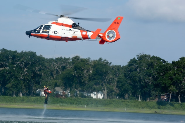 An MH-65 Dolphin helicopter assigned to Coast Guard Air Station Savannah deploys a rescue swimmer to rescue a simulated downed pilot during a Search and Rescue (SAR) exercise July 27. The training was the first SAR exercise to involve F-35B Lightning II pilots.