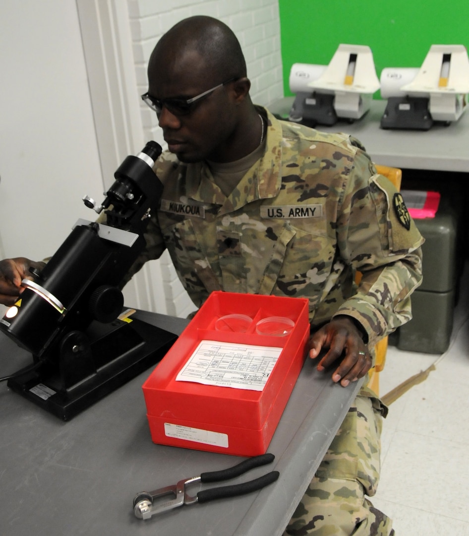 Spc. Kodjo Koukoua, an Army Reserve optical laboratory specialist assigned to 7252nd Medical Support Unit, is processing new eye prescriptions for eyeglass fabrication at Escontrias Early Childhood Center in Socorro, Texas. Koukoua is one of approximately 50 U.S. Army Reserve and U.S. Army Soldiers who are working in partnership with the Texas A&M Colonias program to provide medical care to El Paso County's underserved colonias population.