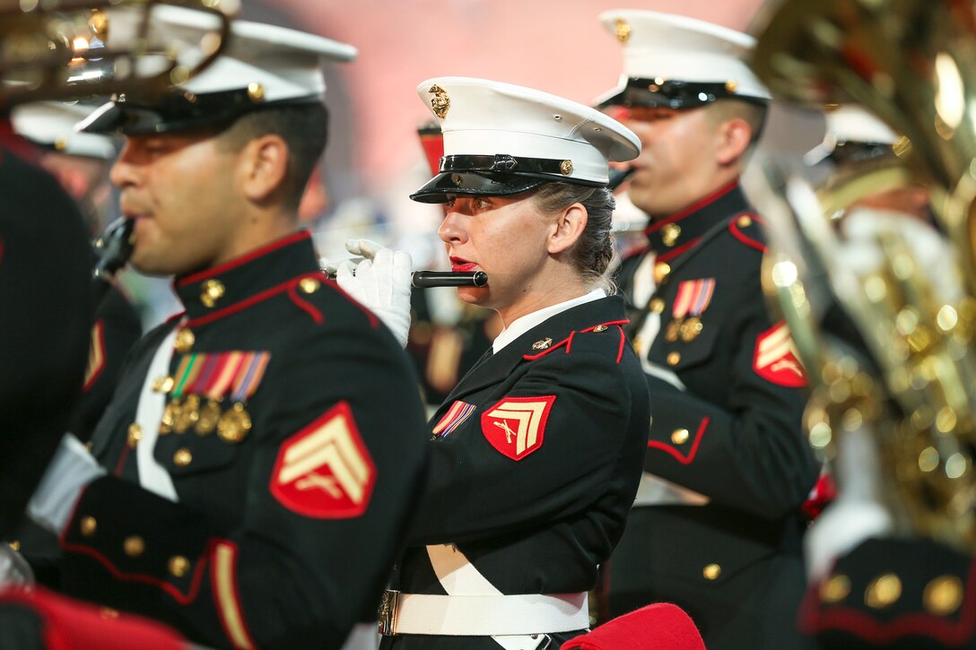Marine Corps musicians stand and play instruments.