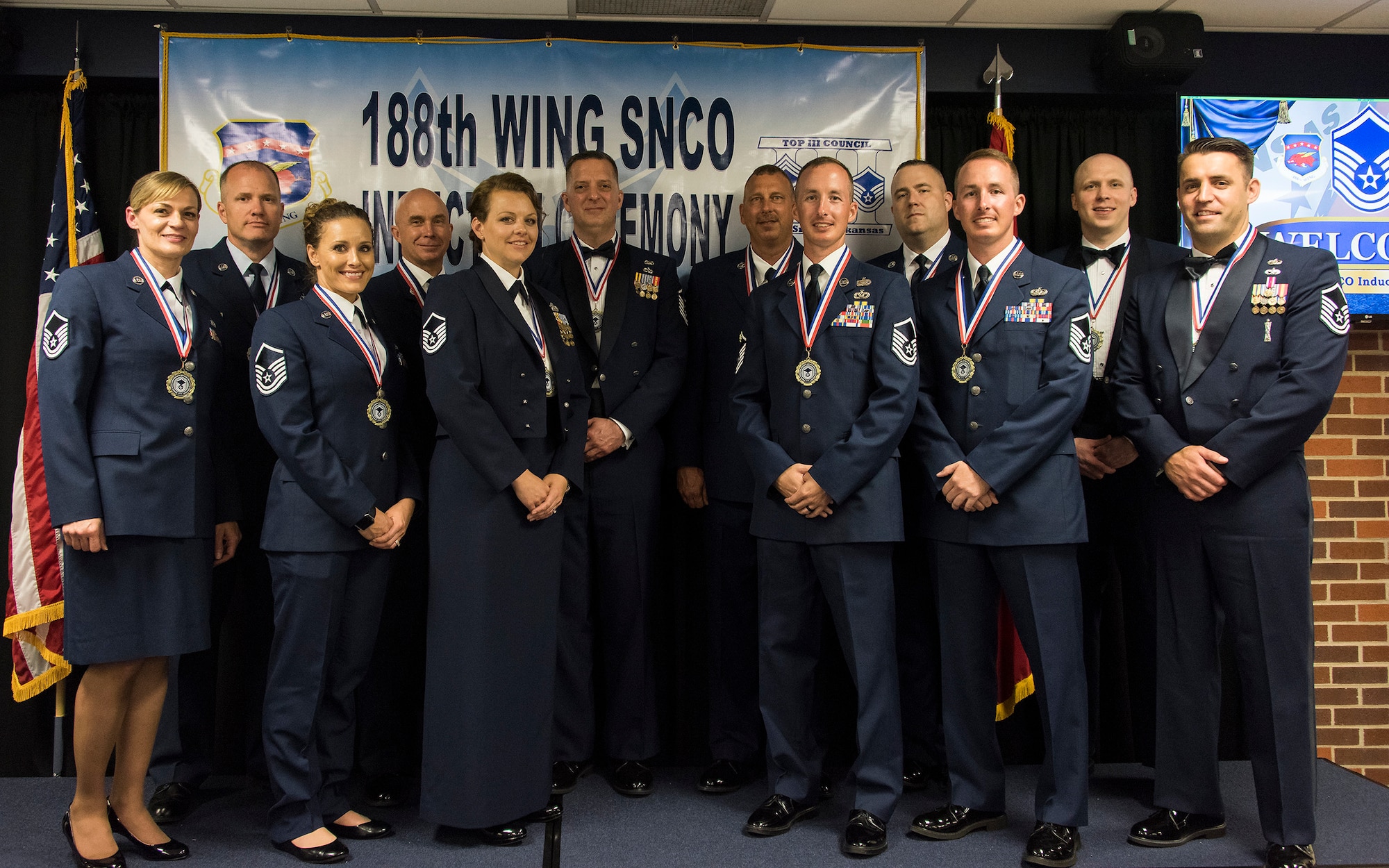 New senior non-commissioned officers with the 188th Wing, Arkansas Air National Guard, pose for a photo during the wing's inaugural Senior Non-commissioned Officer Induction Ceremony, held at Ebbing Air National Guard Base, Ark., June 2, 2018. The wing celebrated the accomplishments of its newest senior NCOs during the evening's event. (U.S. Air National Guard photo by Tech. Sgt. John E. Hillier)