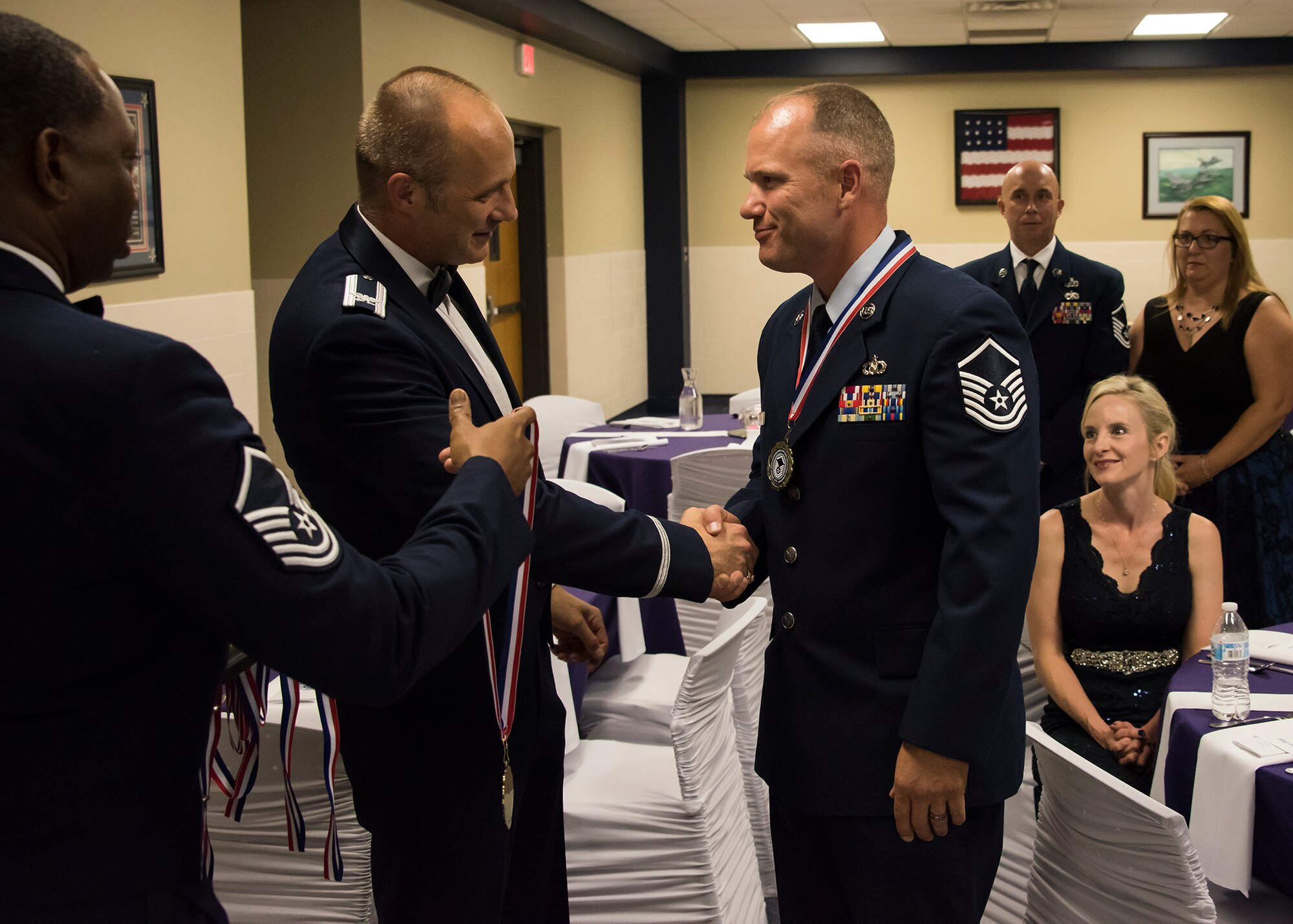 188th Wing Commander, Col. Robert I. Kinney, present the wing's new senior non-commissioned officers with a medallion during the wing's inaugural Senior NCO Induction Ceremony held at Ebbing Air National Guard Base, Ark., June 2, 2018. The wing celebrated the accomplishments of its newest senior NCOs during the evening's event. (U.S. Air National Guard photo by Tech. Sgt. John E. Hillier)