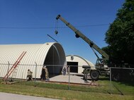U.S. Army Reserve Soldiers from the 317th Engineer Company, out of Homewood, Ill., assemble metal sections on a 4,000 square foot Quonset hut at Joliet Training Area, in Elwood, Ill., as part of a Troop Support Project during their Annual Training, July 18.