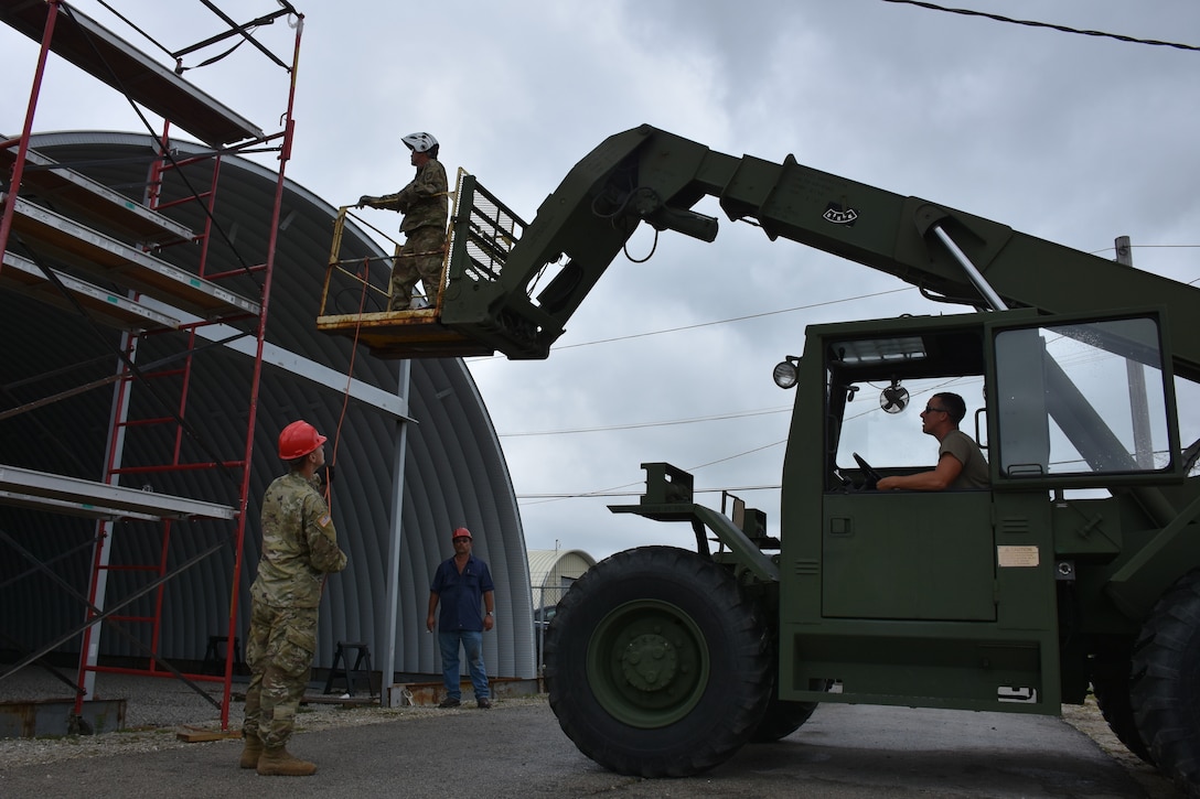 U.S. Army Reserve Soldiers from the 317th Engineer Company, out of Homewood, Ill., weld metal sections together on a 4,000 square foot Quonset hut at Joliet Training Area, in Elwood, Ill., as part of a Troop Support Project during their Annual Training, July 20.
