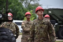 U.S. Army Reserve Soldiers from the 317th Engineer Company, out of Homewood, Ill., act as safety officers during the assembly of a 4,000 square foot Quonset hut at Joliet Training Area, in Elwood, Ill., July 20.