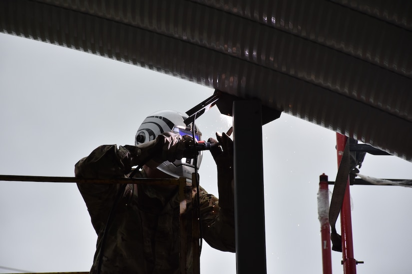 U.S. Army Reserve Staff Sgt. Harold Bevill, a combat engineer with the 317th Engineer Company, out of Homewood, Ill., welds metal sections together on a 4,000 square foot Quonset hut at Joliet Training Area, in Elwood, Ill., as part of a Troop Support Project during Annual Training, July 20.