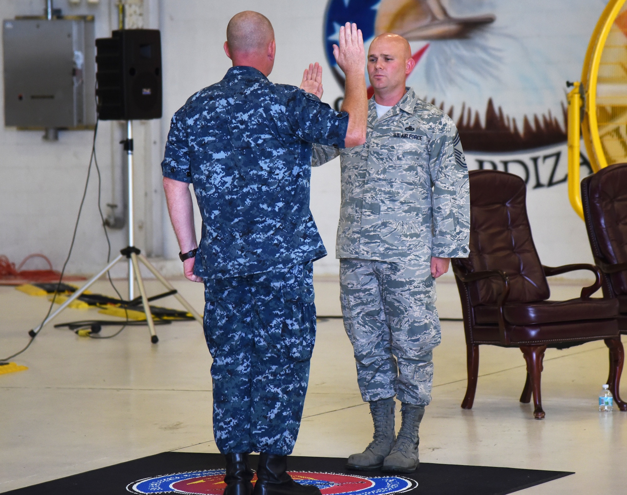 U.S. Navy Cmdr. Matthew Scott administers the oath of office to Chief Master Sgt. Matthew Coltrin during the first enlisted frocking ceremony in Air Education and Training Command on Aug. 1, 2018 at Eglin AFB, Fla. A frocking ceremony allows a military member to pin on new rank prior to their promotion date. (U.S. Air Force photo by 1st Lt. Savannah Stephens)