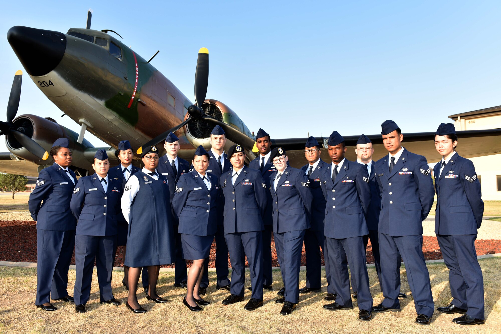 Airman Leadership School Class 18-E stands before the EC-47 static plane display on Goodfellow Air Force Base, Texas, July 24, 2018. ALS is a six-week course designed to prepare senior airmen to assume supervisory duties by offering instruction in leadership, followership, written and oral communication skills, and the profession of arms. (U.S. Air Force photo by Senior Airman Randall Moose/Released)