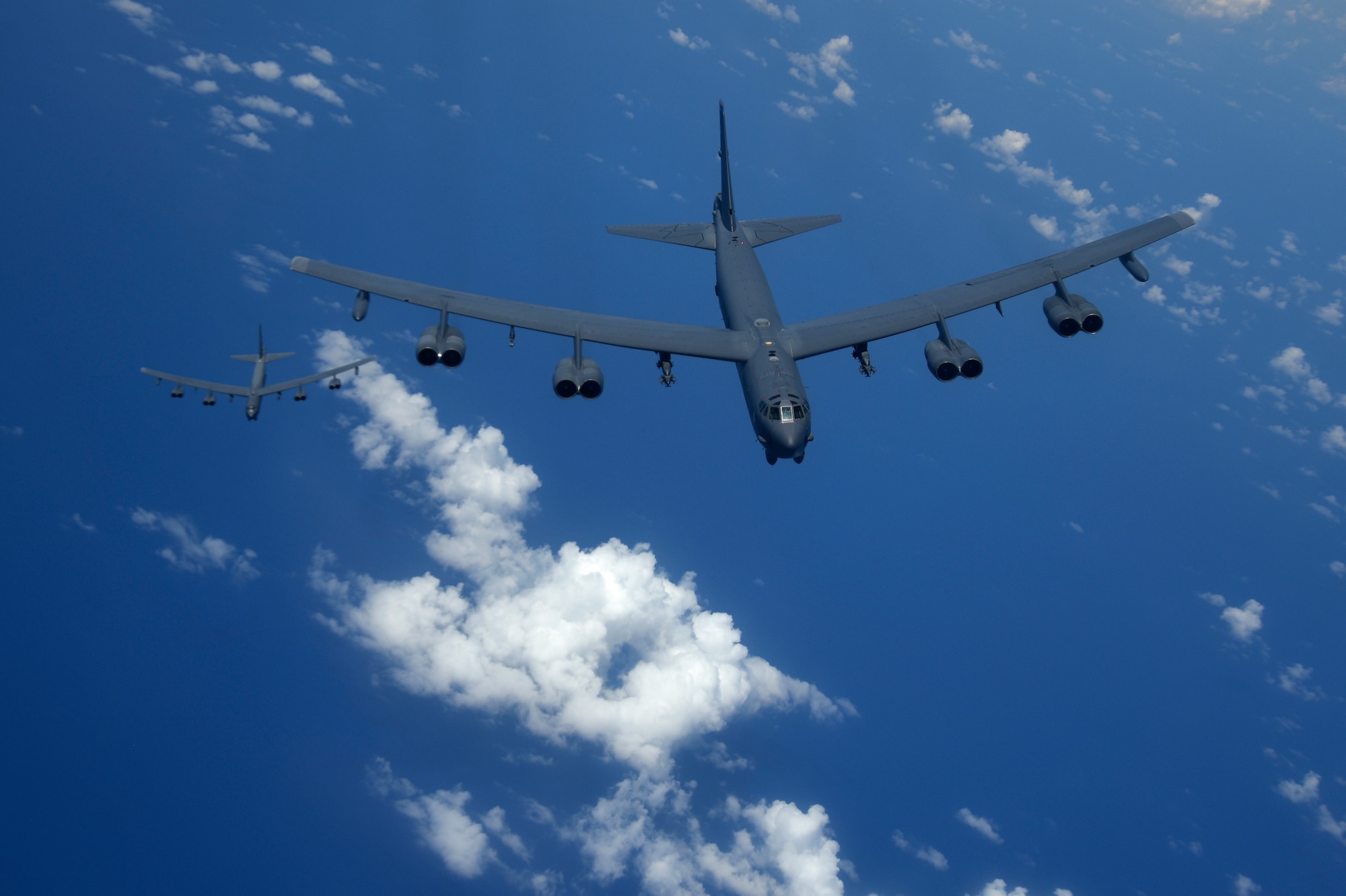Two U.S. Air Force B-52H Stratofortress bombers fly over the Pacific Ocean during a routine training mission Aug. 2, 2018. This mission was flown in support of U.S. Indo-Pacific Command’s Continuous Bomber Presence operations, which are a key component to improving combined and joint service interoperability. (U.S. Air Force photo by Airman 1st Class Gerald R. Willis)