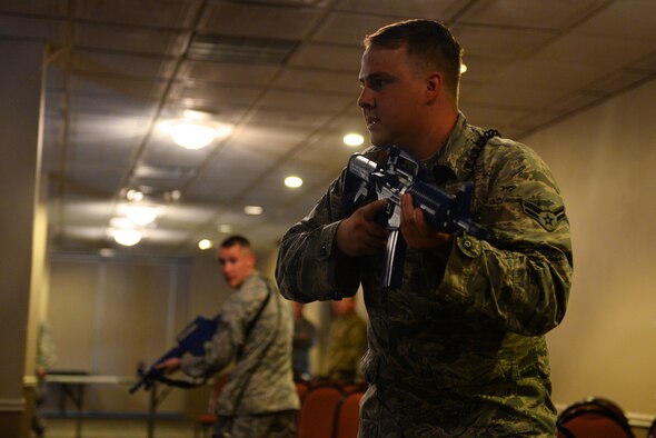 Airman 1st Class Christopher Shelton, 47th Security Forces Squadron patrolman, scans his surroundings in a training scenario at Laughlin Air Force Base, Texas, Aug. 1, 2018. The 47th SFS, along with the 47th Civil Engineer Squadron firefighters, recently started training with a new and improved process aimed at cutting down response time to active shooter scenarios. (U.S. Air Force photo by Senior Airman Benjamin N. Valmoja)
