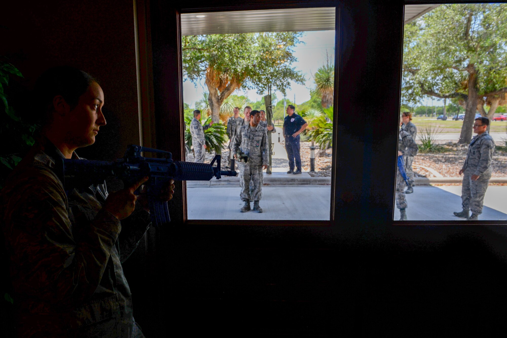 Senior Airman Ashley Knowland, 47th Security Forces Squadron patrolman, keeps watch during a training scenario at Laughlin Air Force Base, Texas, Aug. 1, 2018. The 47th SFS, along with the 47th Civil Engineer Squadron firefighters, recently started training with a new and improved process aimed at cutting down response time to active shooter scenarios. (U.S. Air Force photo by Senior Airman Benjamin N. Valmoja)