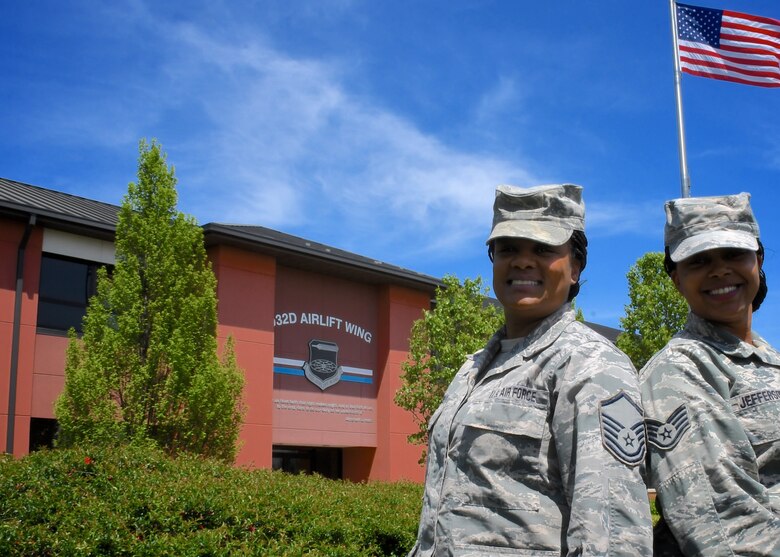 Serving in Illinois with the Air Force Reserve Command, Master Sgt. Kelly Willis and Staff Sgt. Alexandria Jefferson, both aviation management specialists with the 932nd Aeromedical Evacuation Squadron, enjoy a moment in front of the United States flag.  They stopped by the 932nd Airlift Wing headquarters building during a recent unit training assembly.  (U.S. Air Force photo by Lt. Col. Stan Paregien)