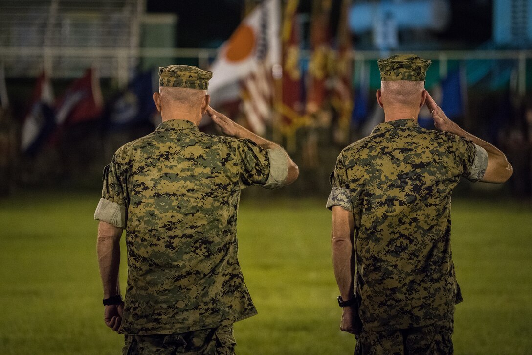 Lt. Gen. Eric M. Smith (right) and Lt. Gen. Lawrence D. Nicholson (left) salute the troops during a pass and review during a III Marine Expeditionary Force change of command ceremony, Aug. 2, 2018, at the parade deck aboard Camp Courtney, Okinawa, Japan. Smith assumed his duties as the III MEF commanding general. Smith arrived from 1st Marine Division where he served as commanding general. (U.S. Marine Corps photo by Sgt. Matthew J. Bragg)