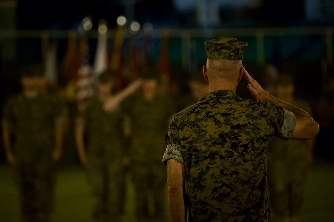 Lt. Gen. Eric M. Smith, incoming commanding general of III Marine Expeditionary Force, salutes the commander of troops during the III MEF change of command ceremony Aug 2, 2018, at Camp Courtney, Okinawa, Japan. Prior to assuming his duties as the commanding general of III MEF, Smith served as the commanding general of 1st Marine Division. (U.S. Marine Corps photo by Lance Cpl. Harrison Rakhshani)