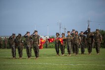 Platoon commanders and platoon sergeants stand with the company colors of Headquarters Regiment, 3rd Marine Logistics Group, during a relief and appointment ceremony for Headquarters Regiment, 3rd Marine Logistics Group, Aug. 3, 2018 at Camp Kinser, Okinawa, Japan. Sgt. Maj. James E. Monroe ceremoniously transferred accountability and authority of enlisted Marines to Hammock during the ceremony. (U.S. Marine Corps photo by Lance Cpl. Jamin M. Powell)