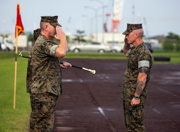 Sgt. Maj. Jason Hammock, right, salutes Col. Scott R. Johnson, left, before taking the noncommissioned officer sword of office during a relief and appointment ceremony for Headquarters Regiment, 3rd Marine Logistics Group, Aug. 3, 2018 at Camp Kinser Okinawa, Japan. Sgt. Maj. James E. Monroe ceremoniously transferred accountability and authority of enlisted Marines to Hammock during the ceremony. Monroe is a native of Brewton, Alabama. Hammock is a native of Miami, Florida. (U.S. Marine Corps photo by Cpl. Joshua S. Pinkney)