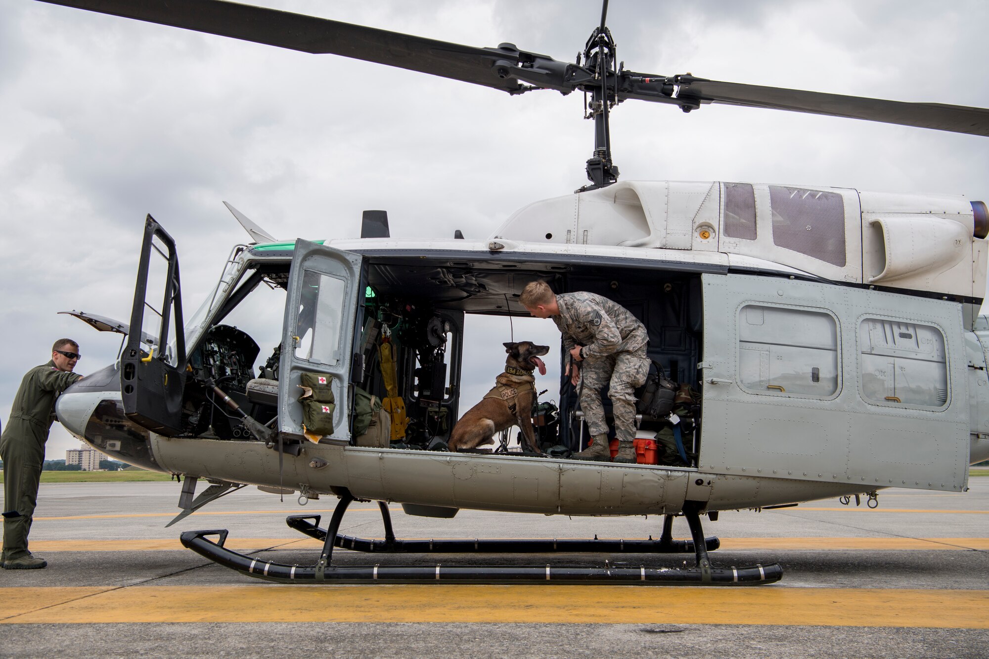 Staff Sgt. Cody Nickell, 374th Security Forces Squadron military working dog handler, works with Topa, 374 SFS MWD, to get him accustomed to being inside a UH-1N helicopter during a 459th Airlift Squadron MWD familiarization flight July 26, 2018, at Yokota Air Base, Japan.