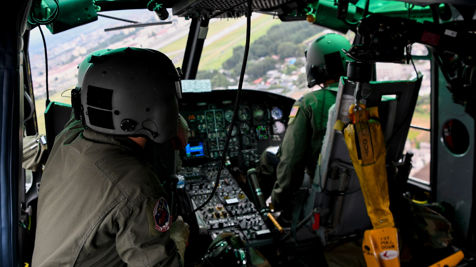 Members of the 459th Airlift Squadron fly a UH-1N helicopter during a 456 AS MWD familiarization flight July 26, 2018, over Yokota Air Base, Japan.