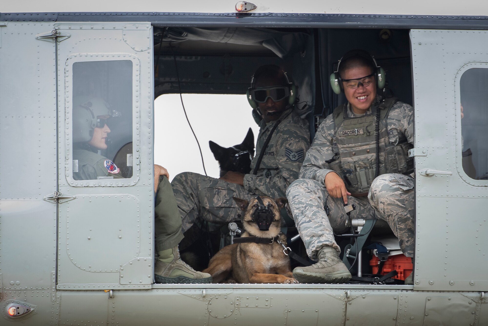 Staff Sgt. Michael Dacoron, 374th Security Forces Squadron military working dog handler, and Diesel, 374 SFS MWD, wait for takeoff in a UH-1N helicopter during a 459th Airlift Squadron MWD familiarization flight July 26, 2018, at Yokota Air Base, Japan.