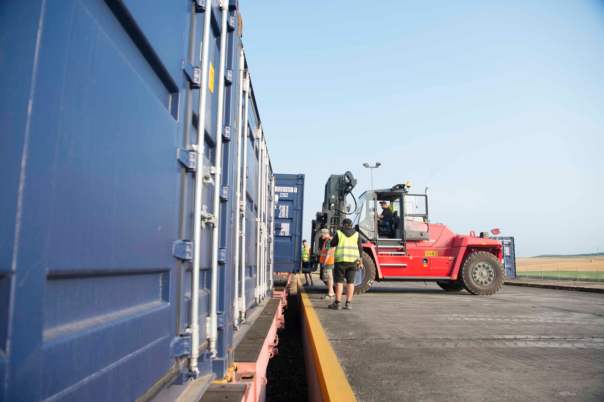 A forklift operator places cargo onto a train car in Sanem, Luxembourg, July 23, 2018. The cargo was used during a Deployable Air Base System construction exercise in Krzesiny Air Base, Poland. An estimated 55 U.S. Air Force and Army personnel deployed to Poland to support the DABS construction, which tested the Air Force's ability to rapidly construct an air base in an austere environment. (U.S. Air Force photo by Senior Airman Elizabeth Baker)