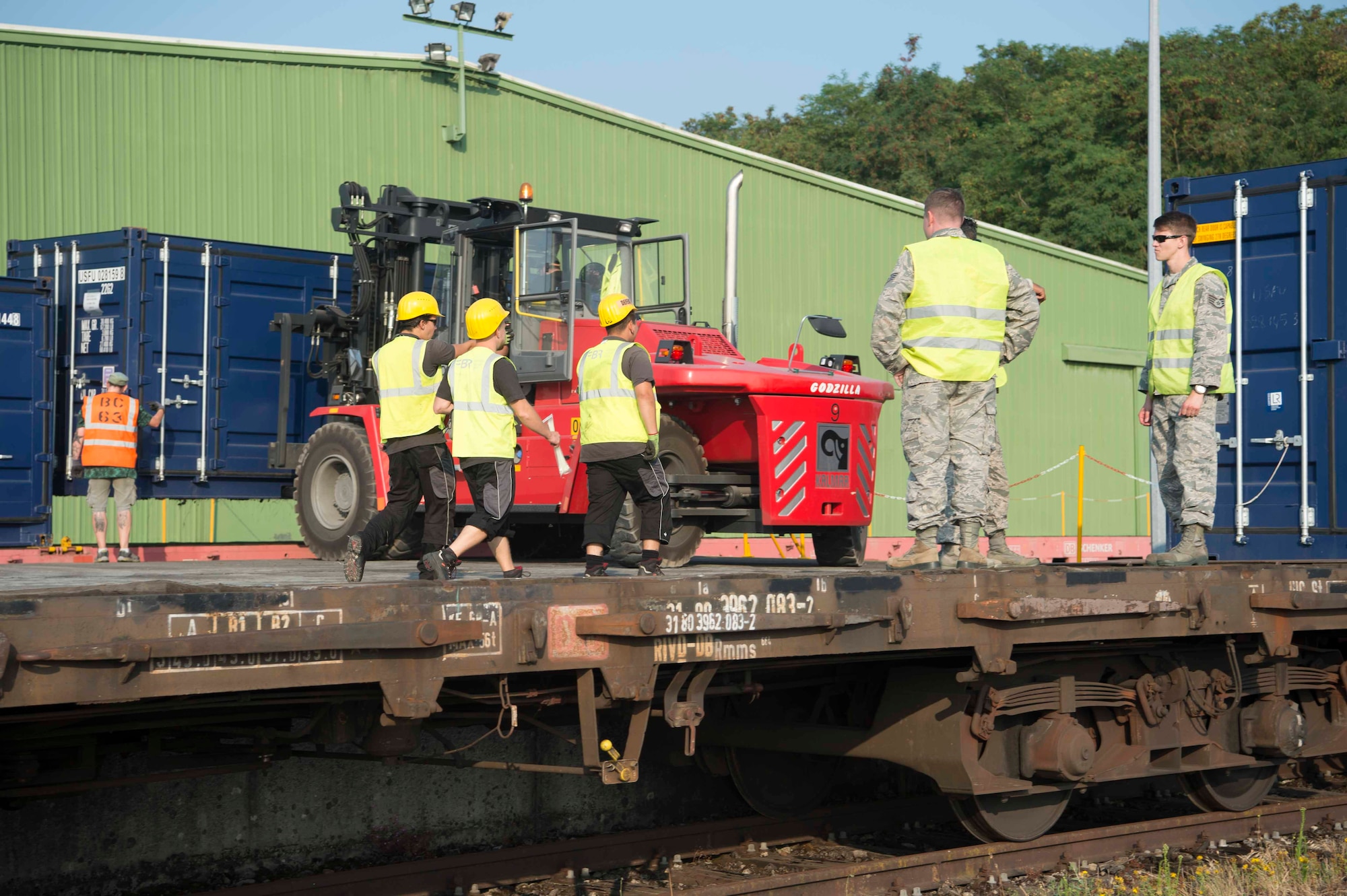 U.S. Air Force Airmen oversee Warehouse Service Agency personnel load cargo onto a train car in Sanem, Luxembourg, July 23, 2018. The loading was part of a deployment exercise in which a variety of vehicles and equipment travelled via train to Krzesiny Air Base, Poland. WSA stores and maintains the assigned 86th Material Maintenance Squadron's equipment and ensures that it is ready to rapidly deploy when needed. (U.S. Air Force photo by Senior Airman Elizabeth Baker)
