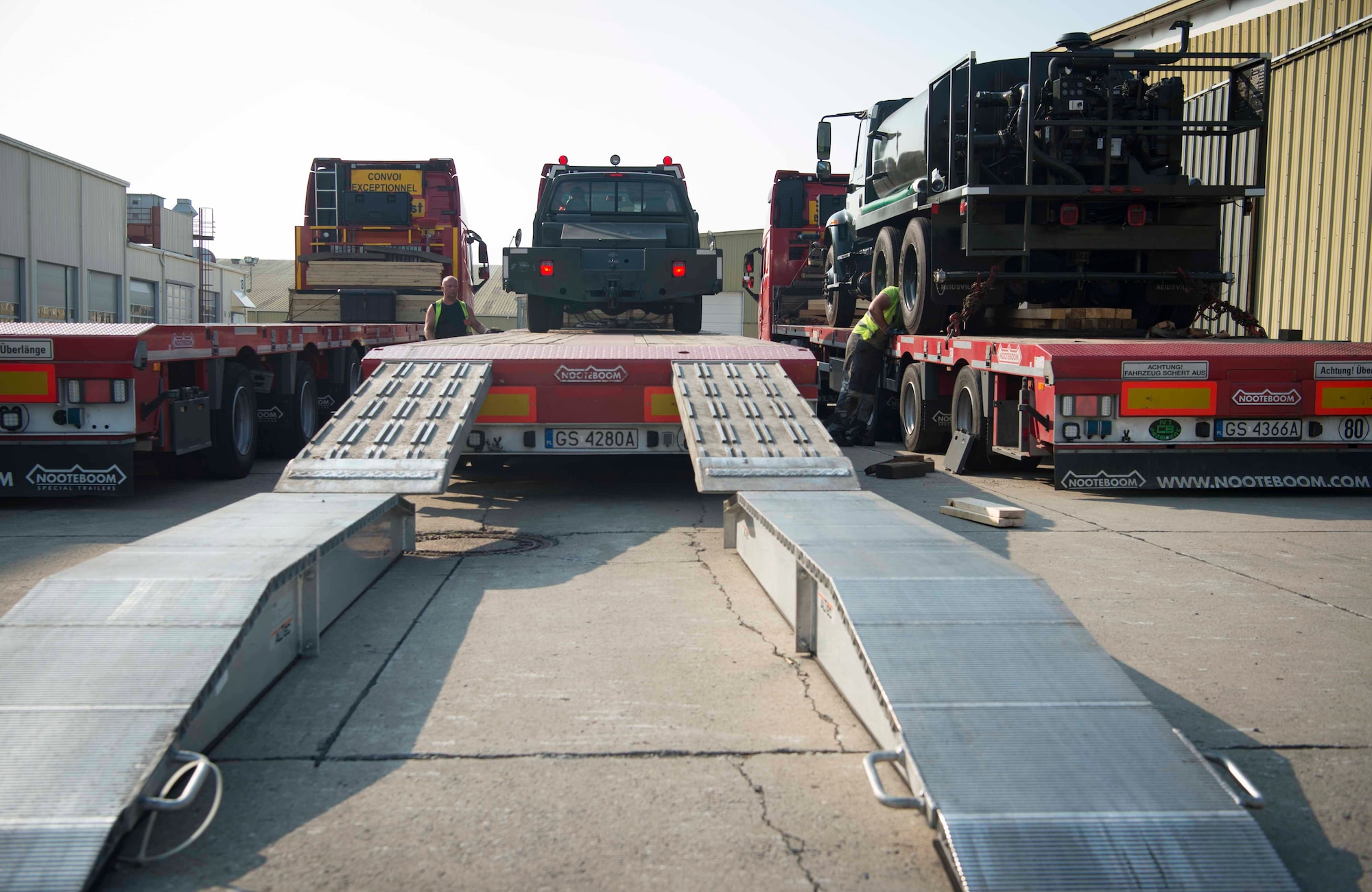 U.S. air Force Master Sgt. Israel Rivera, 86th Material Maintenance Squadron vehicle management flight chief, parks a tow truck on a semi trailer truck in Sanem, Luxembourg, July 23, 2018. A variety of vehicles and equipment traveled via truck and train from Luxembourg to Krzesiny Air Base, Poland, to contribute to a Deployable Air Base System construction exercise. The U.S. stores prepositioned equipment in Europe, ready for deployment, to ensure necessary combat power is available for response to crisis. (U.S. Air Force photo by Senior Airman Elizabeth Baker)