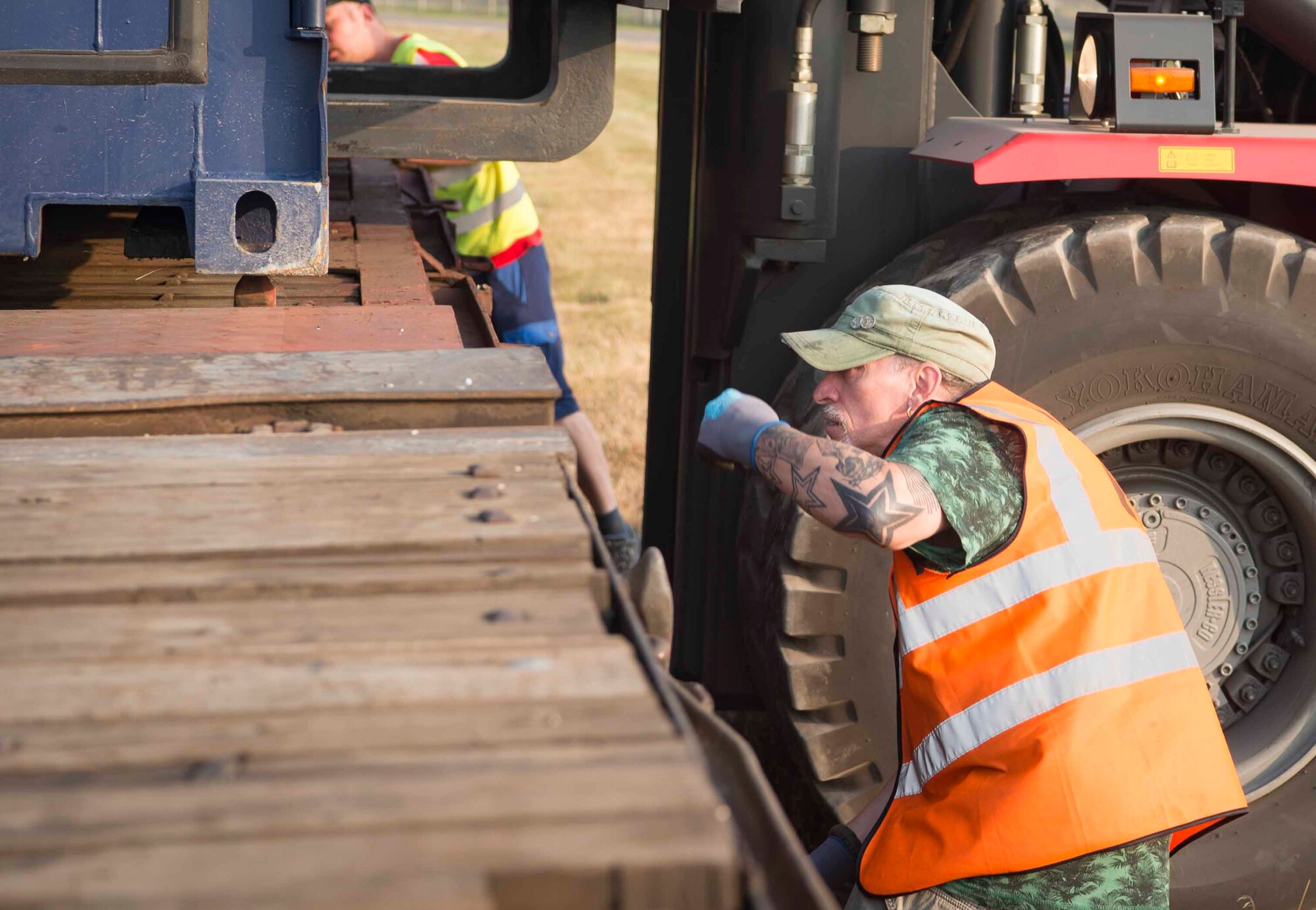 A Warehouse Service Agency employee directs a forklift operator to lower cargo onto a train car in Sanem, Luxembourg, July 23, 2018. The cargo travelled to Krzesiny Air Base, Poland, as part of a deployment exercise to test the U.S. military's ability to rapidly process, deploy, and set up facilities, equipment, and vehicles in a location where little infrastructure exists. This was the first time in more than 25 years that the U.S. military has used a railway to transport equipment. (U.S. Air Force photo by Senior Airman Elizabeth Baker)