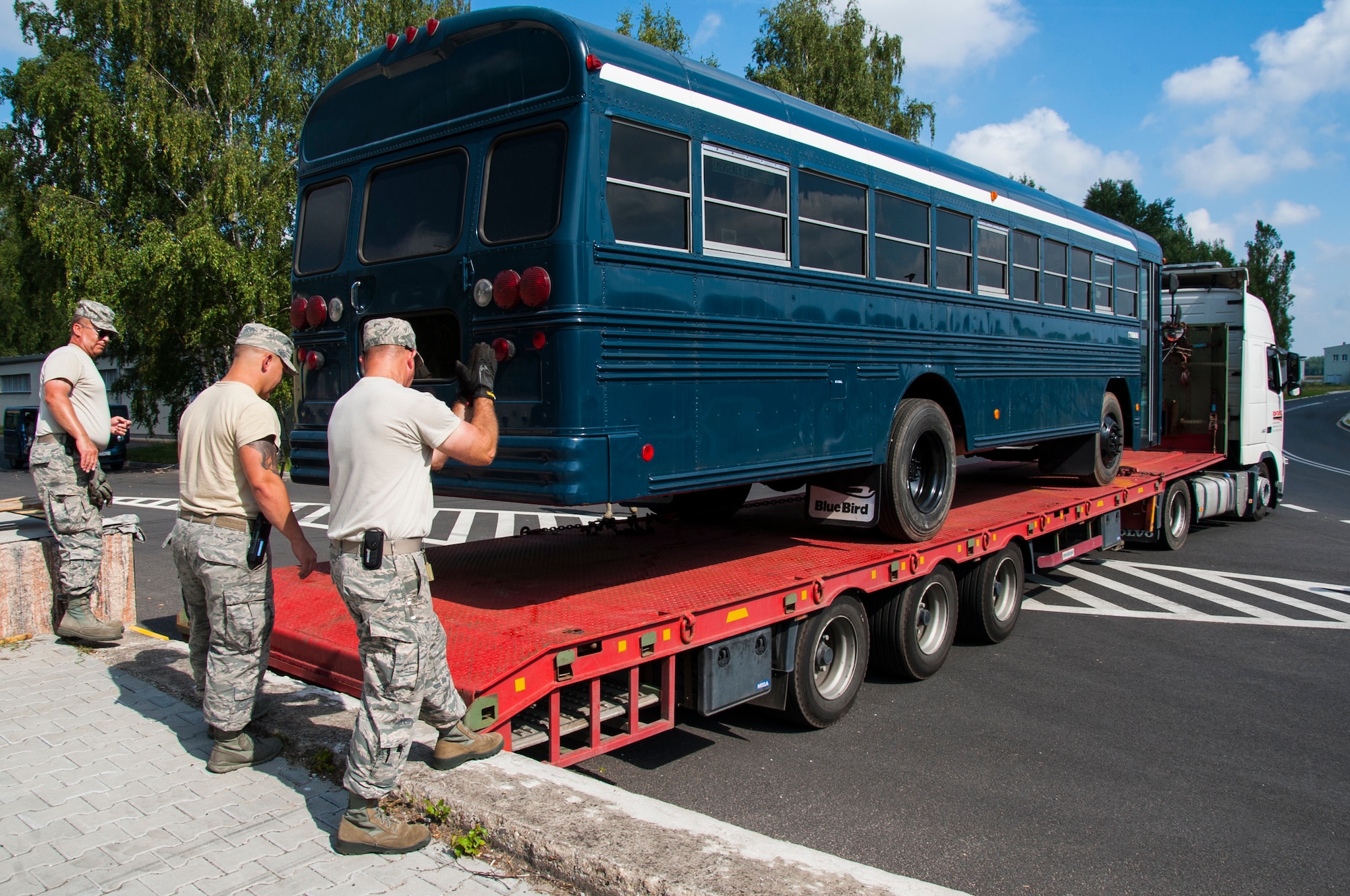 U.S. Air National Guard Airmen guide a truck to an off-loading dock during the Deployable Air Base System proof of concept exercise at the 31st Tactical Air Base, Poznan-Krzesiny, Poland, July 30, 2018. The exercise tests and enhances the ability to rapidly deploy within theatre, preposition equipment and enables the execution of current operations, exercises and contingencies. (U.S. Army photo by Spc. Craig Jensen)