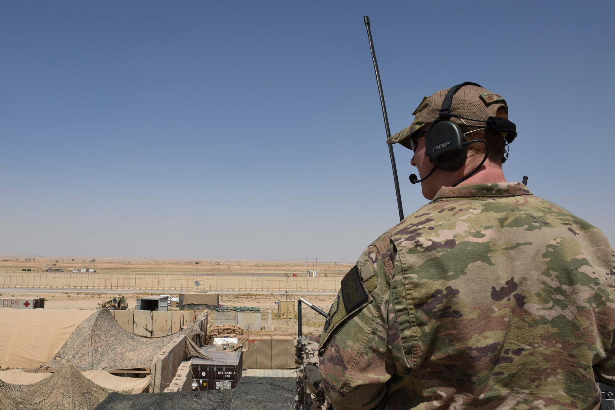 Senior Airman Brennan Gettinger, a 447th Air Expeditionary Group air traffic controller, directs air traffic from a tower July 17, 2018, at Qayyarah Airfield West, Iraq. Q-West is a forward operating base that supports strategic airlift for Operation Inherent Resolve. (U.S. Air Force photo by Tech. Sgt. Caleb Pierce)